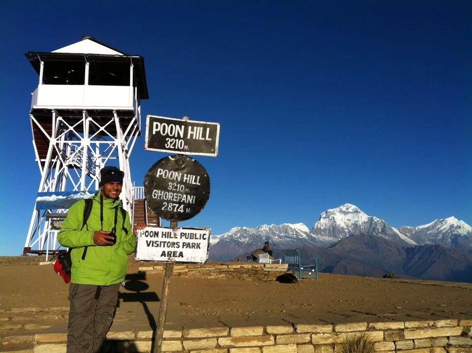 single man at top of poon hill